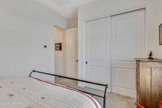 unfurnished bedroom featuring a closet and light colored carpet