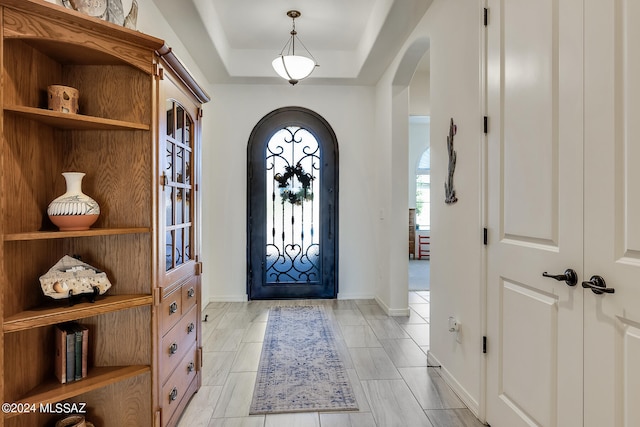 foyer entrance featuring a raised ceiling