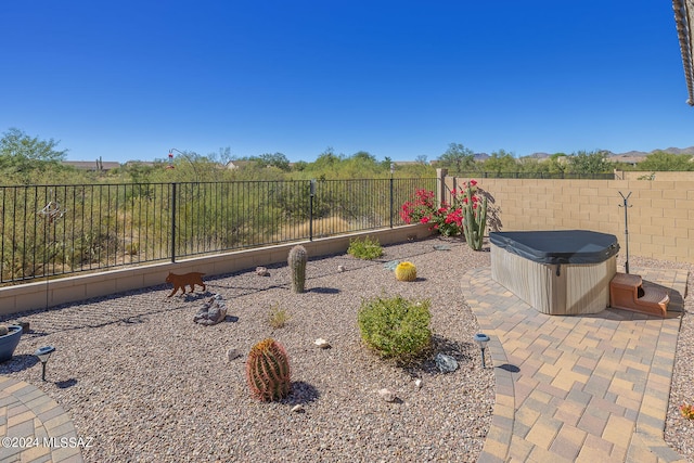 view of yard featuring a hot tub and a patio