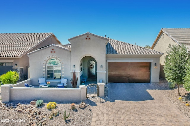 mediterranean / spanish house with a garage