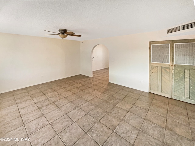 unfurnished room featuring ceiling fan and a textured ceiling