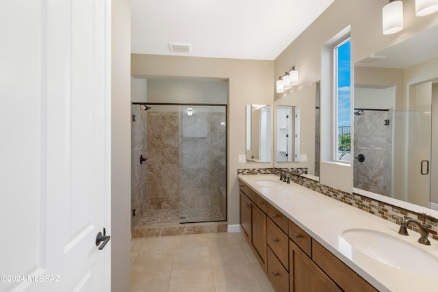 bathroom with tile patterned flooring, a shower with door, and vanity