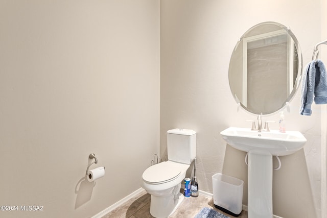 bathroom with tile patterned floors, sink, and toilet