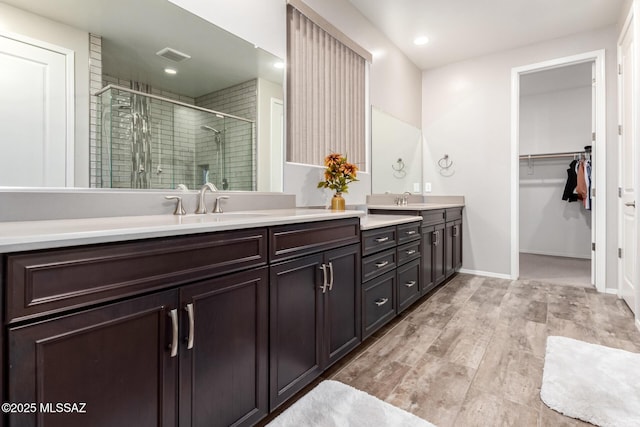 bathroom featuring vanity and a shower with shower door