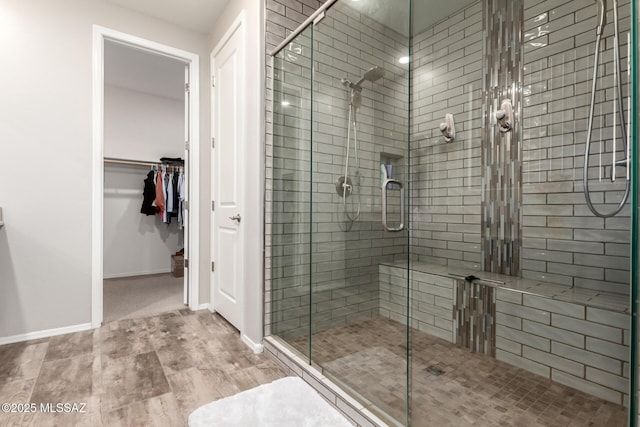 bathroom with an enclosed shower and hardwood / wood-style floors