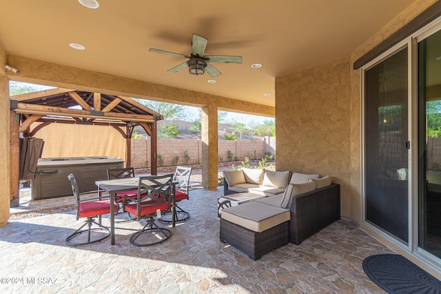 view of patio featuring a gazebo, ceiling fan, a hot tub, and outdoor lounge area