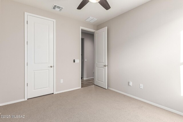 unfurnished bedroom featuring ceiling fan and carpet