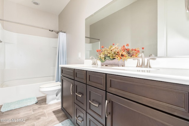 full bathroom with vanity, shower / bath combination with curtain, and toilet