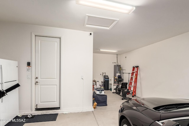 garage with gas water heater and white fridge