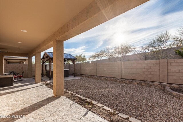 back of property with a patio, a hot tub, a gazebo, and ceiling fan