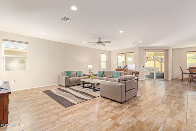 living room featuring light hardwood / wood-style flooring and ceiling fan