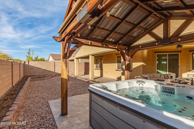 view of patio / terrace featuring an outdoor living space and a hot tub