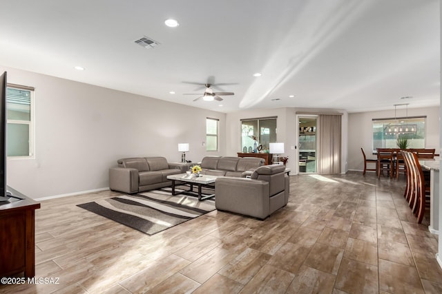 living room featuring ceiling fan and light wood-type flooring