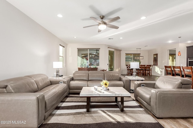 living room featuring light hardwood / wood-style floors and ceiling fan