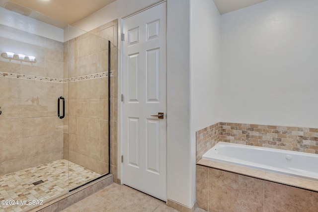 bathroom with tile patterned floors and independent shower and bath