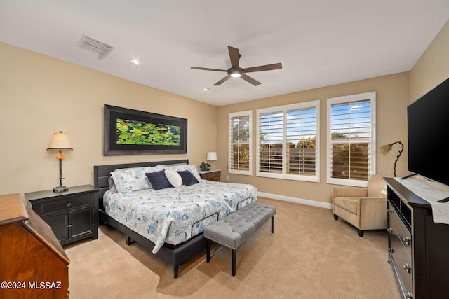 bedroom featuring light colored carpet and ceiling fan