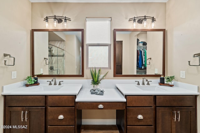 bathroom with vanity and a shower with door