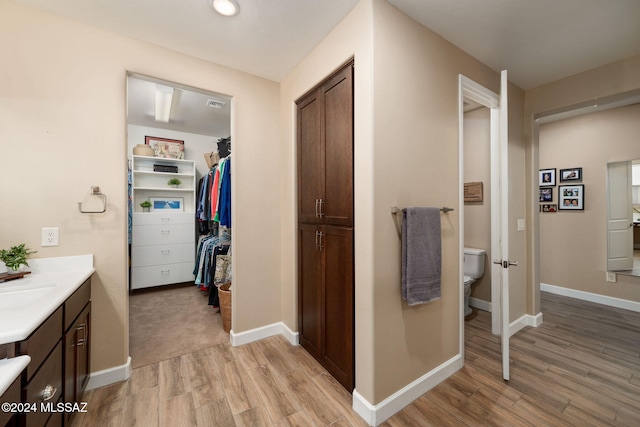 bathroom featuring vanity, toilet, and wood-type flooring