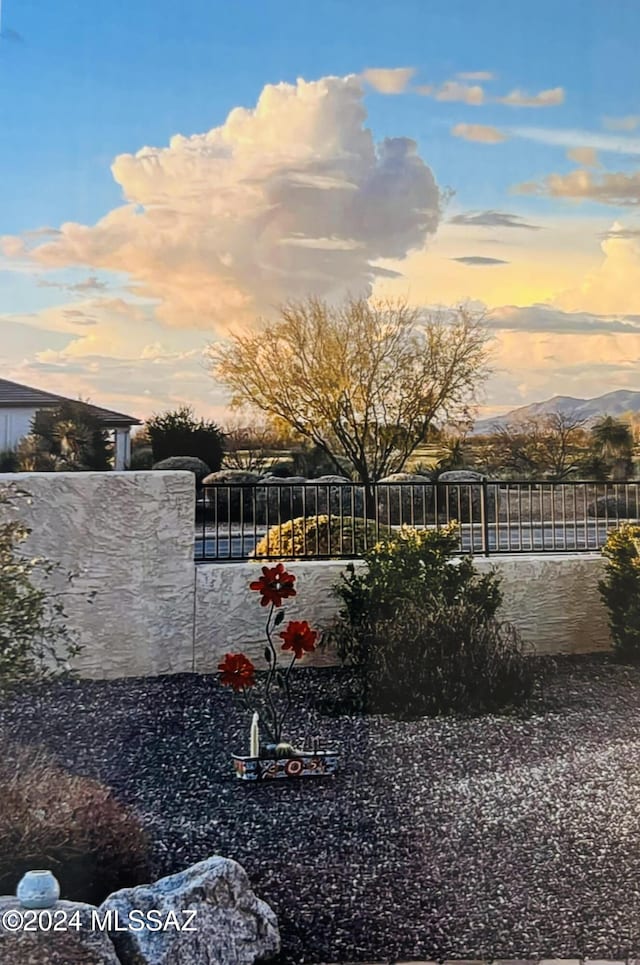 yard at dusk featuring a mountain view