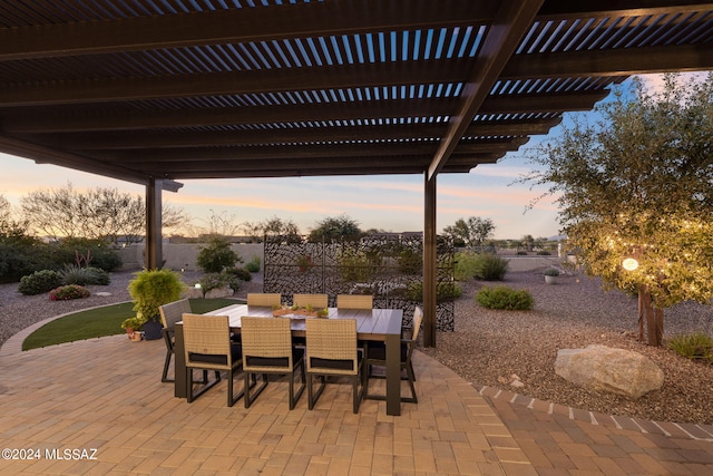 patio terrace at dusk featuring a pergola