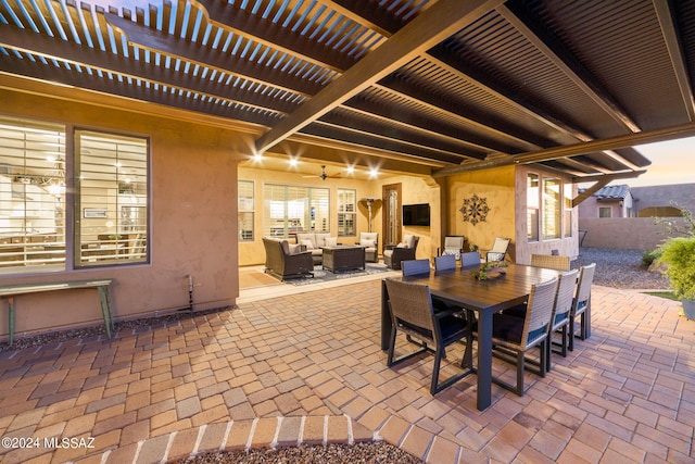 patio terrace at dusk with ceiling fan, outdoor lounge area, and a pergola