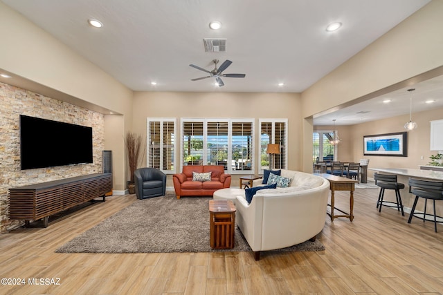 living room featuring light hardwood / wood-style floors and ceiling fan