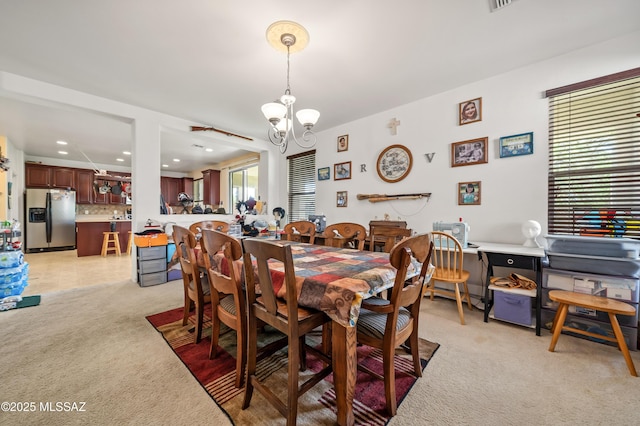 dining area featuring light carpet, recessed lighting, and an inviting chandelier