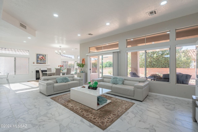 living room featuring a textured ceiling and an inviting chandelier