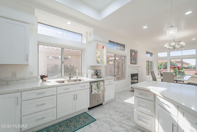 kitchen featuring white cabinets, a healthy amount of sunlight, and stainless steel dishwasher