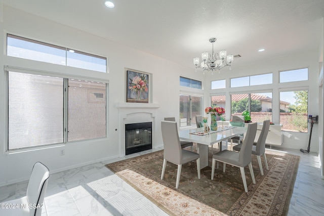 dining room with a chandelier and plenty of natural light