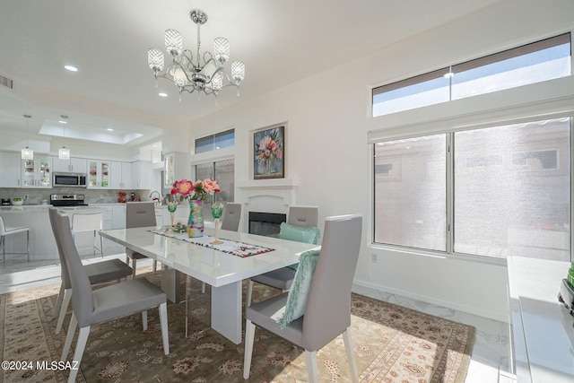 dining space with an inviting chandelier and sink