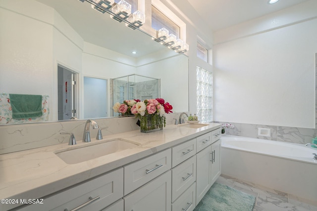 bathroom with vanity and independent shower and bath