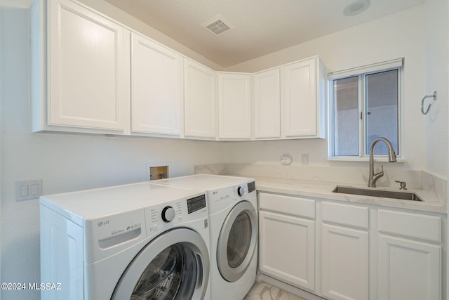 laundry room with sink, washer and clothes dryer, and cabinets