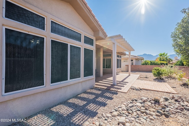 view of patio / terrace with a mountain view and a pergola