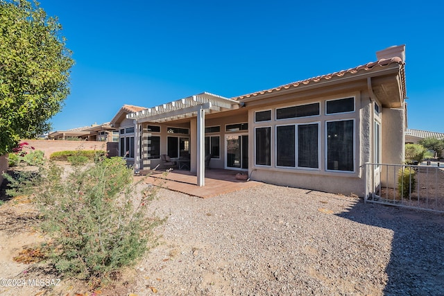 rear view of house featuring a patio and a pergola