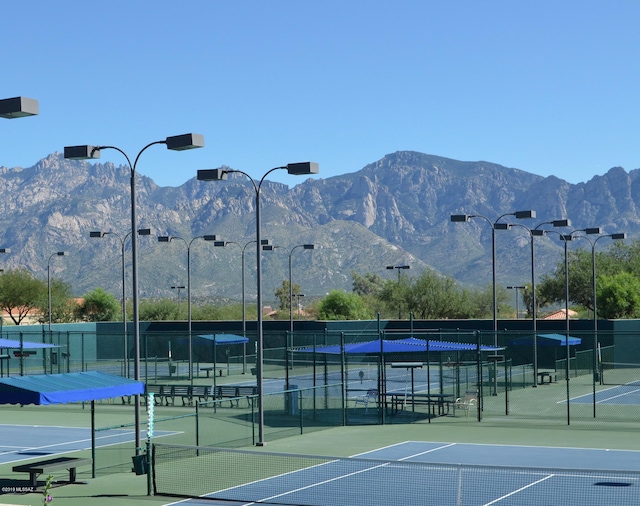 view of tennis court with a mountain view