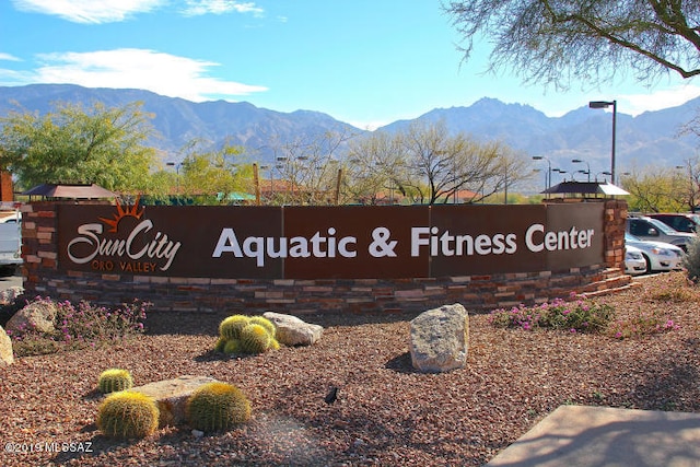 community sign with a mountain view