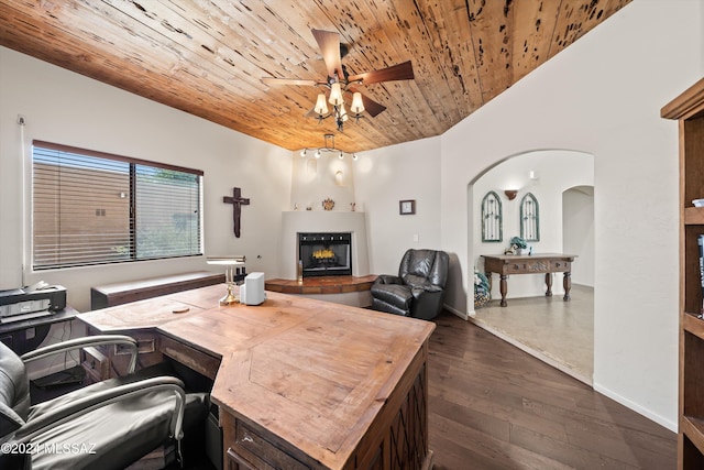 living room with a tile fireplace, ceiling fan, dark wood-type flooring, and wood ceiling