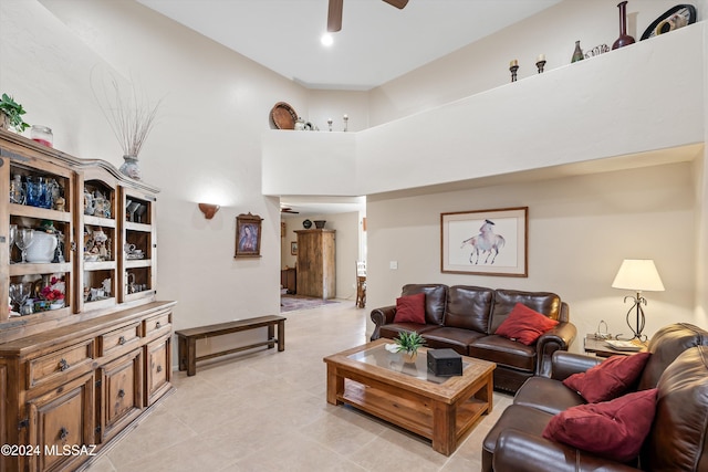 living room featuring a towering ceiling and ceiling fan