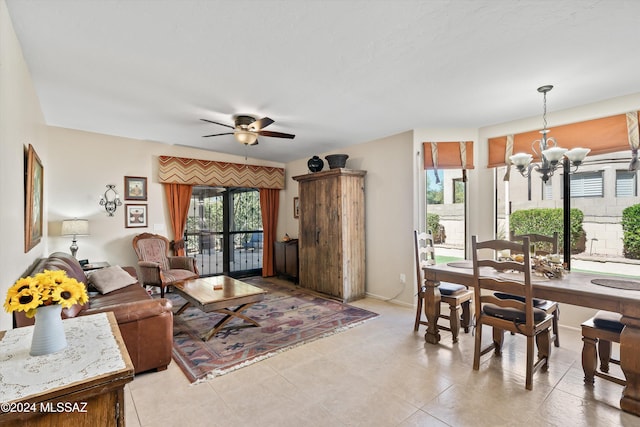 living room featuring ceiling fan with notable chandelier and light tile patterned floors