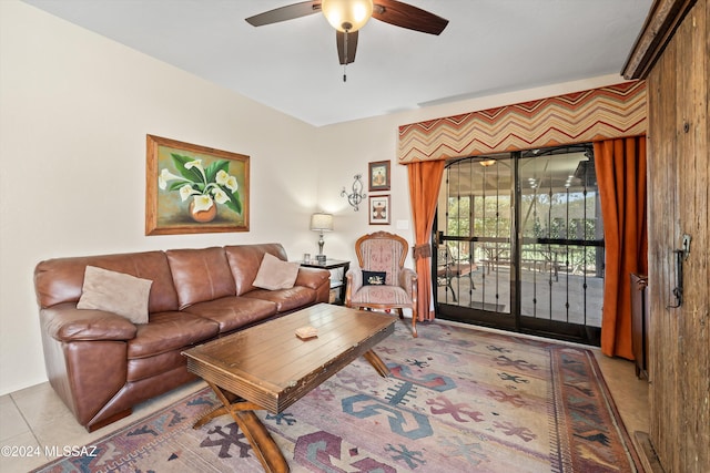 living room featuring ceiling fan and light tile patterned floors