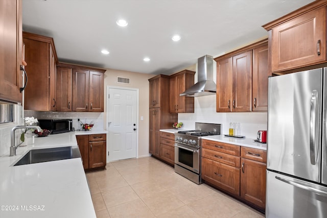 kitchen featuring sink, wall chimney exhaust hood, light tile patterned floors, tasteful backsplash, and stainless steel appliances