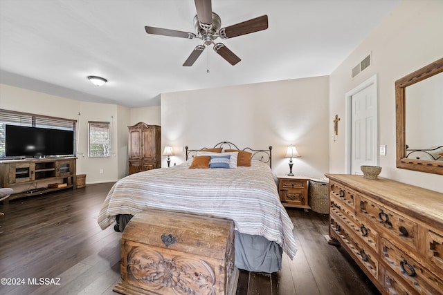 bedroom with dark hardwood / wood-style floors and ceiling fan