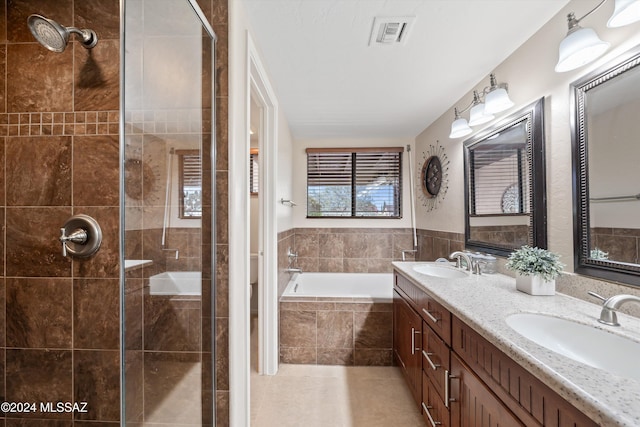 bathroom with plus walk in shower, vanity, and tile patterned flooring