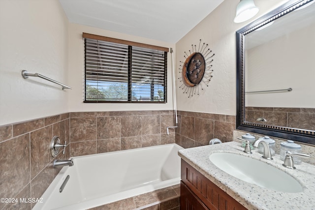 bathroom with a relaxing tiled tub and vanity