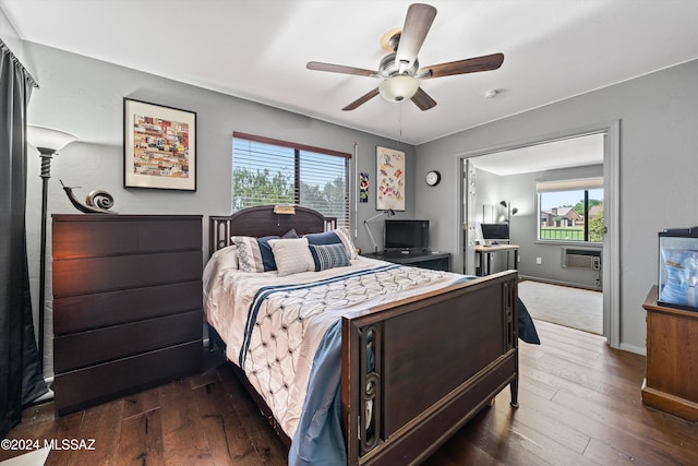 bedroom with multiple windows, ceiling fan, and dark hardwood / wood-style flooring