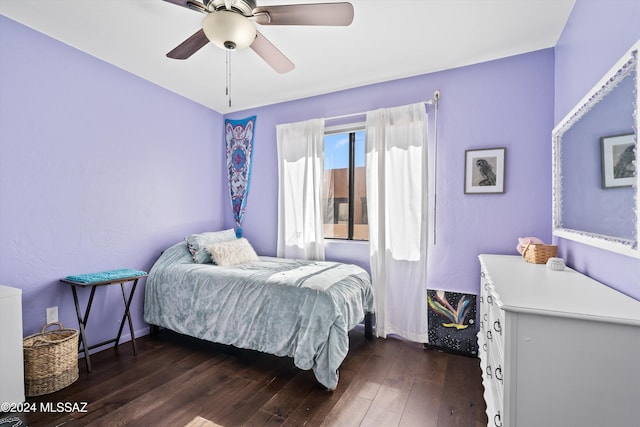 bedroom with ceiling fan and dark wood-type flooring