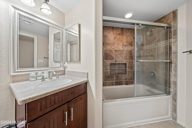 bathroom with shower / bath combination with glass door and vanity