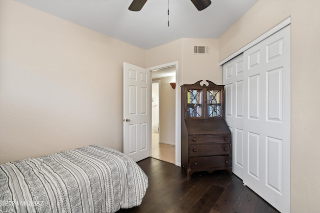 bedroom with ceiling fan, dark hardwood / wood-style flooring, and a closet