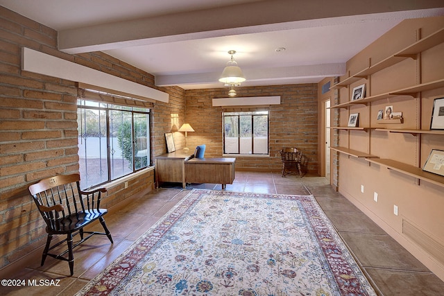 unfurnished room with brick wall, tile patterned floors, and beam ceiling